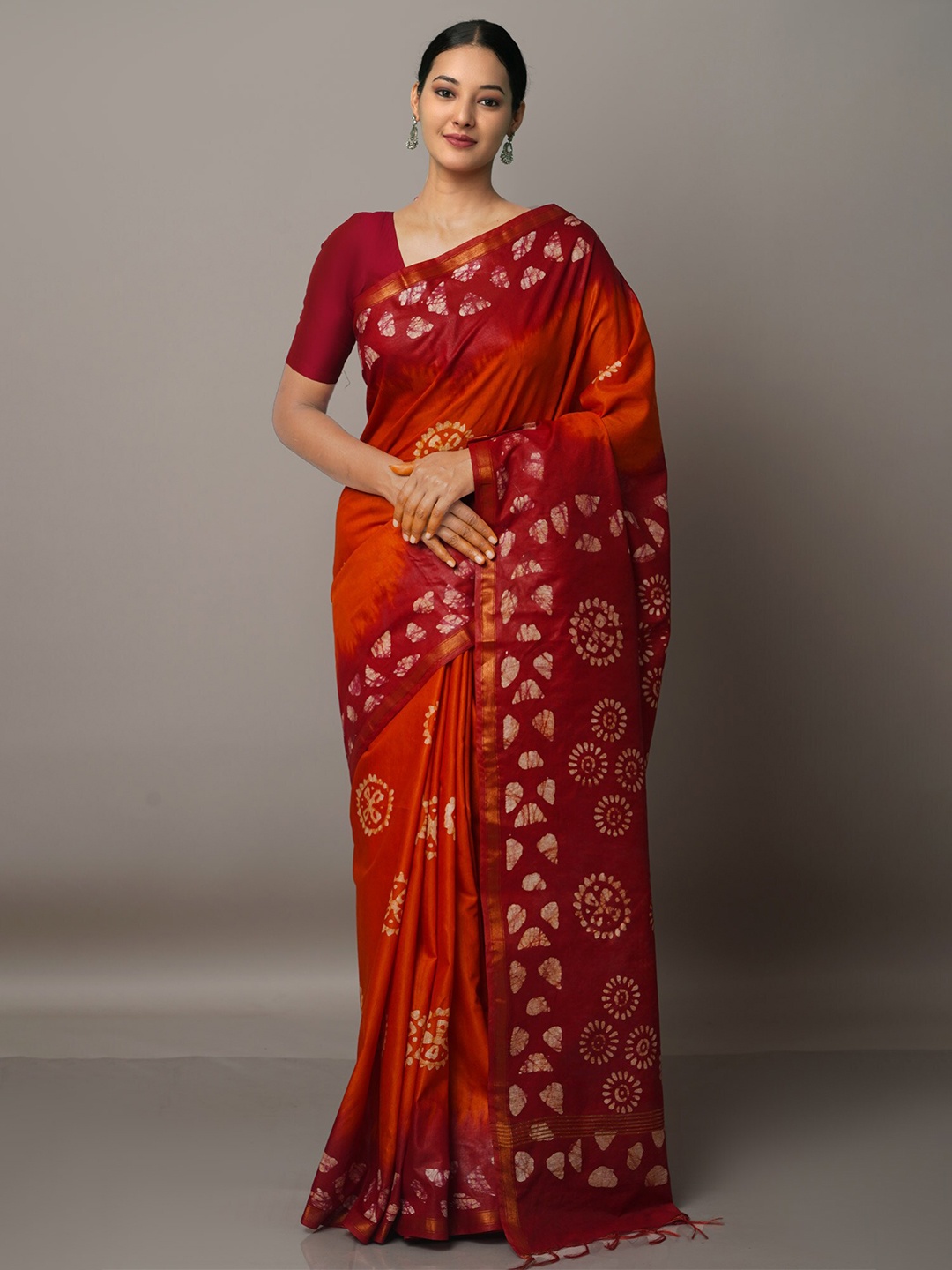 

Unnati Silks Orange & White Batik Zari Silk Blend Bandhani Saree