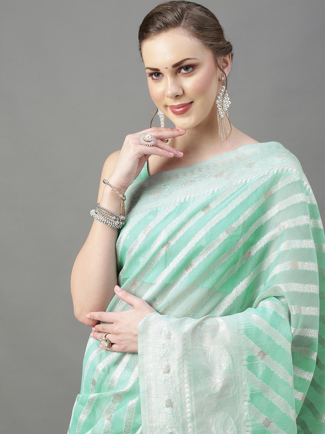 

Mitera Women Sea Green & Silver Ethnic Motifs Zari Silk Cotton Banarasi Saree