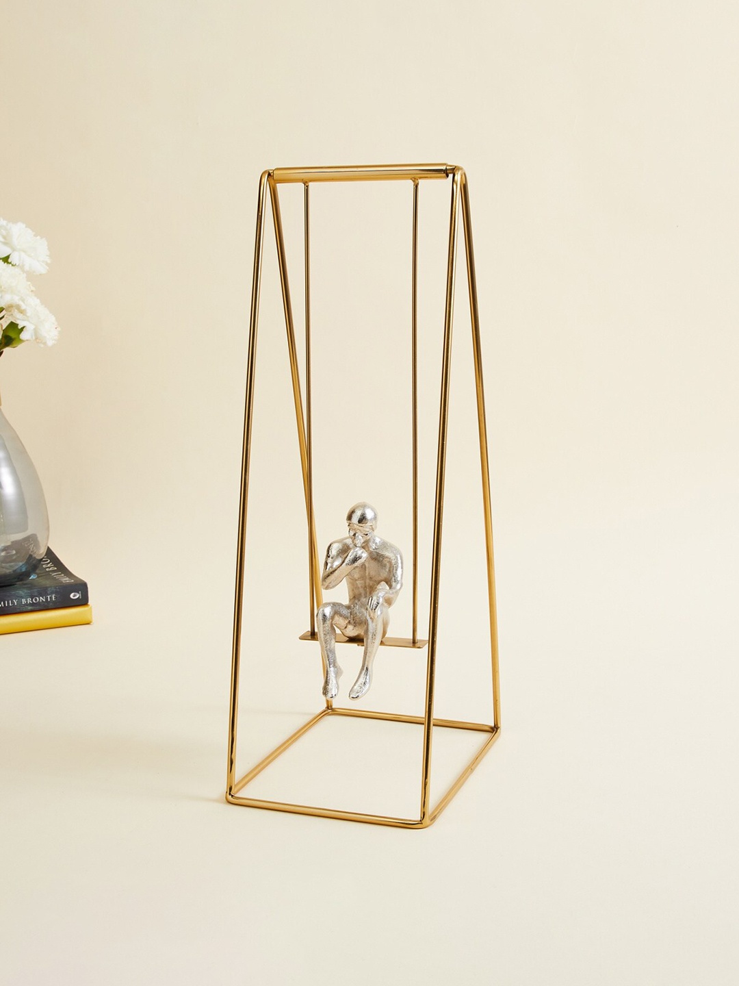 

Home Centre Textured Metal Man On Swing Table Accent Showpieces, Gold