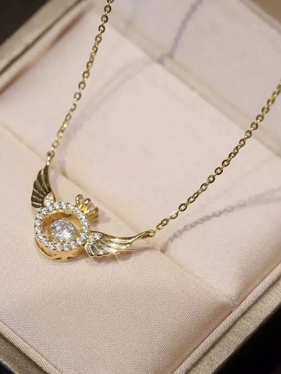 

Vembley Gold-Plated CZ Studded Angel Wings Golden Ring Shape Pendant Necklace