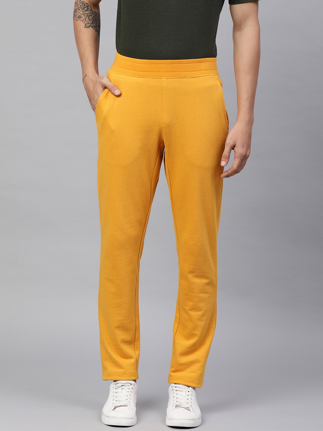 

Huetrap Men Solid Track Pants, Mustard