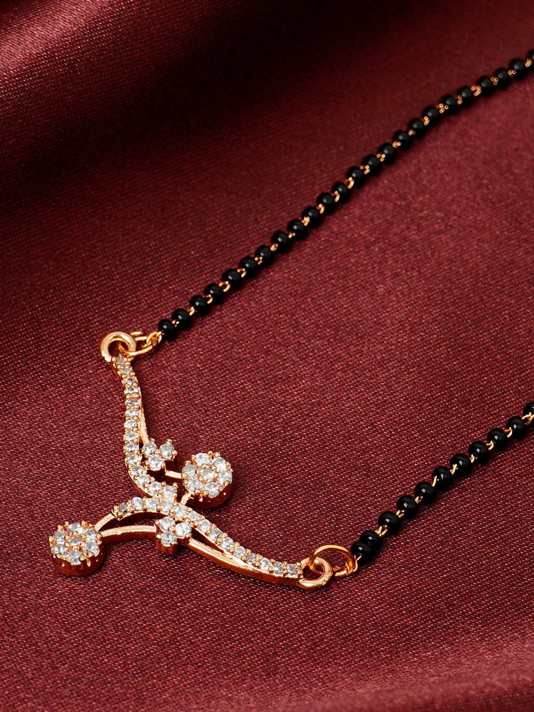 

Urmika Rose-Gold Plated Artificial Stones Studded & Beaded Mangalsutra