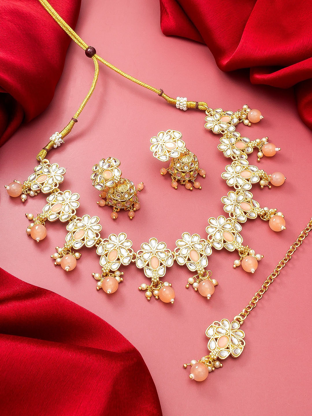 

aadita Gold-Plated Peach Stone Studded Pearl Beaded Temple Choker Jewellery Set