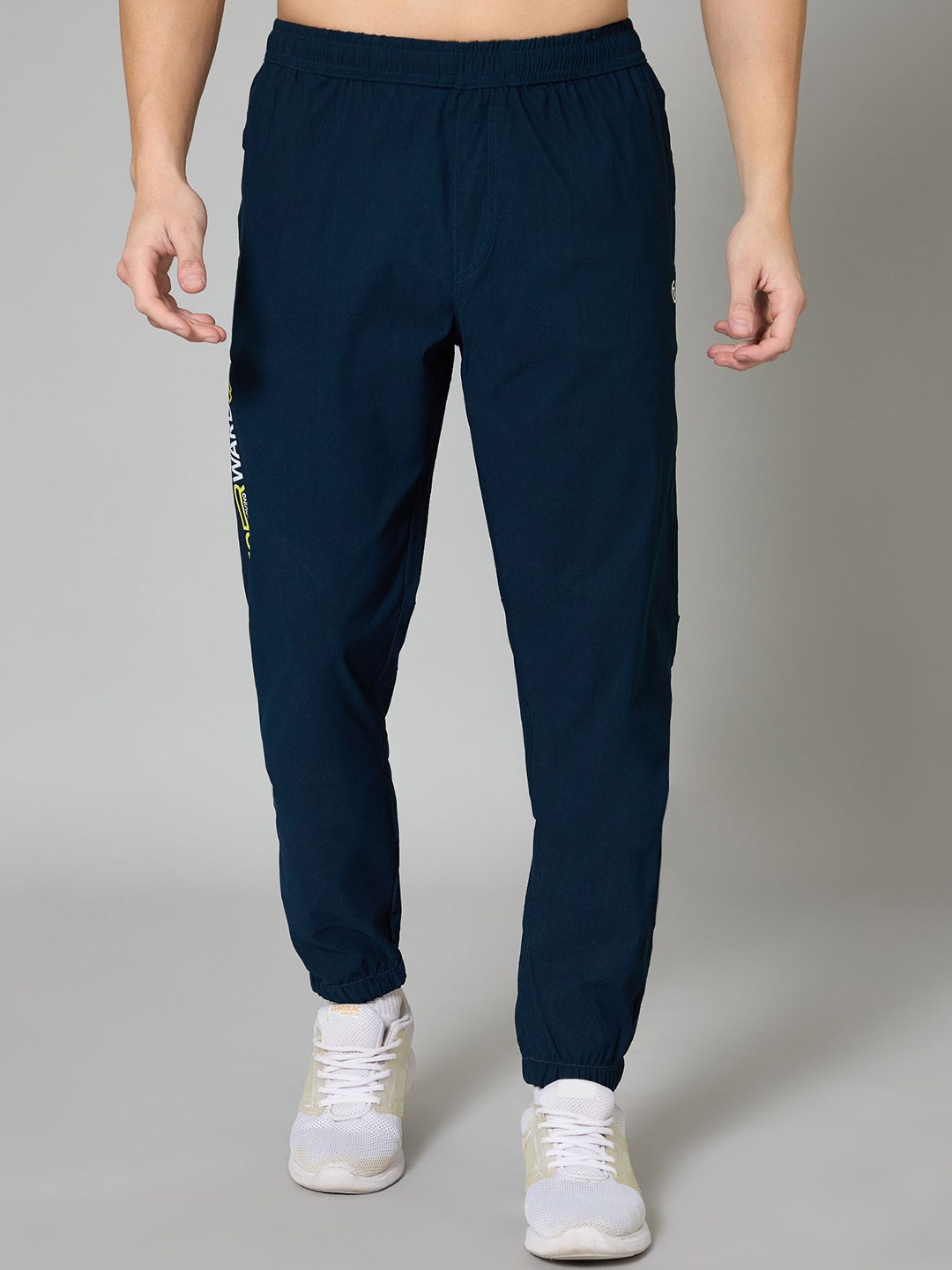 

TURNFIT Men Typographic Printed Mid-Rise Joggers, Green