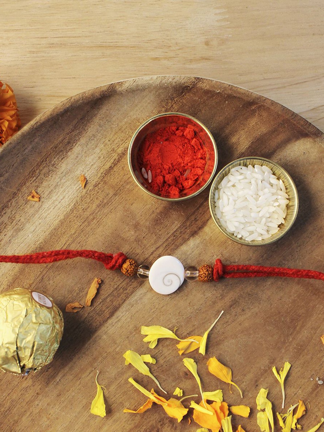 

Shubhanjali Gomti Chakra Rudraksh Thread Rakhi With Roli Chawal & Greeting Card, White