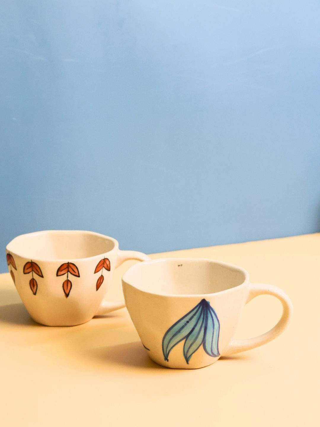 

WEAVING HOMES Beige & Blue 2 Pieces Printed Ceramic Glossy Finished Cups 220 ml Each