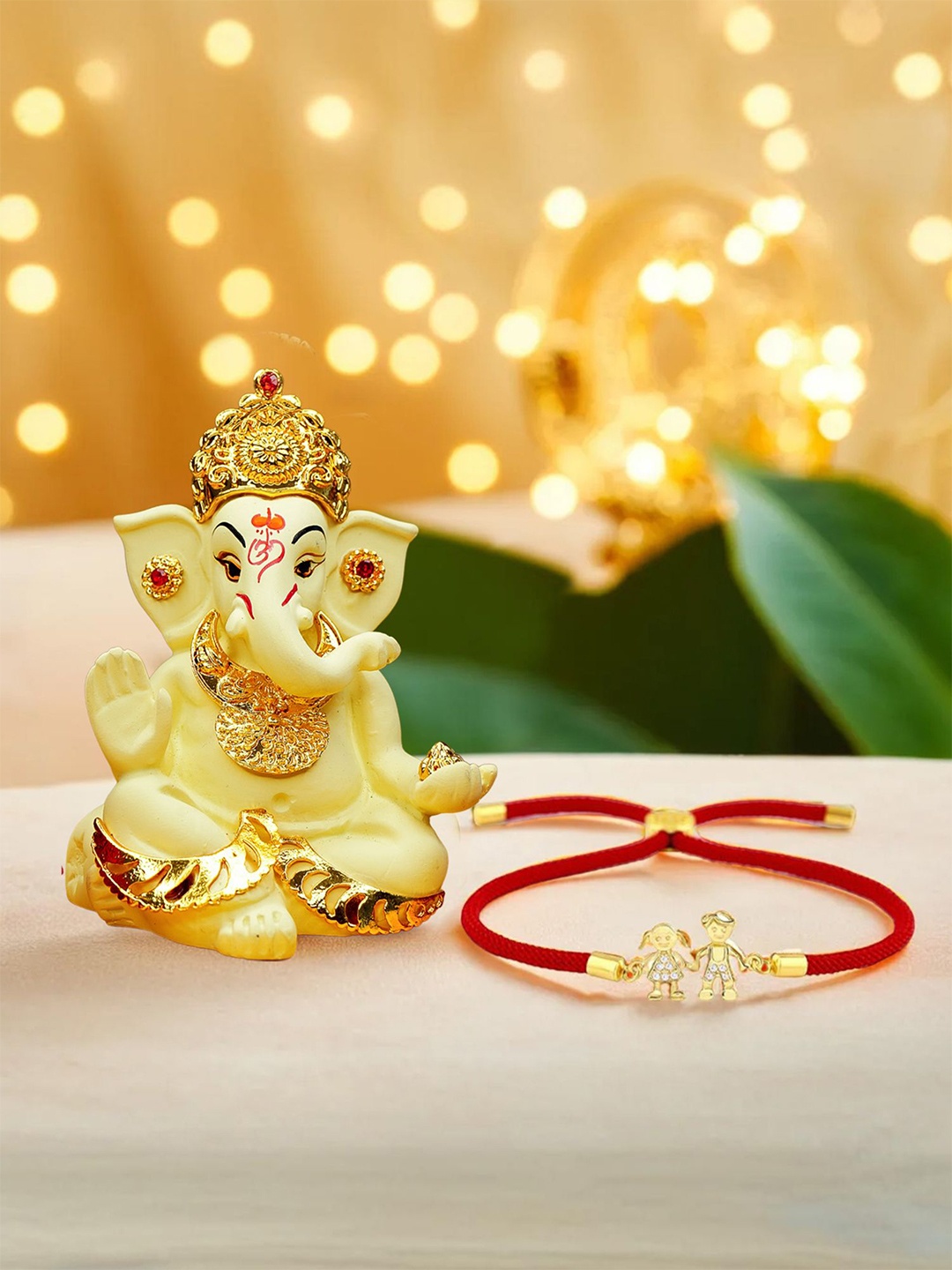 

Ekhasa Set Of 2 Thread Rakhi With Ganesha Idol Rakhi Gift Set, Gold
