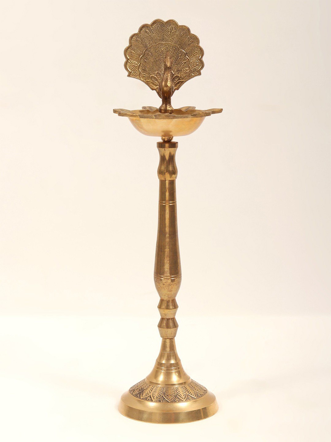 

Exotic India Textured Peacock Pooja Oil Lamp, Gold