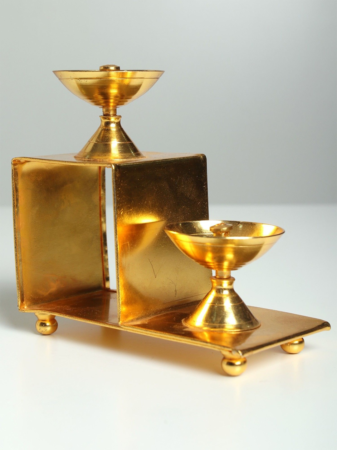 

Exotic India Brass Lamps on Two Steps Stair Stand, Gold