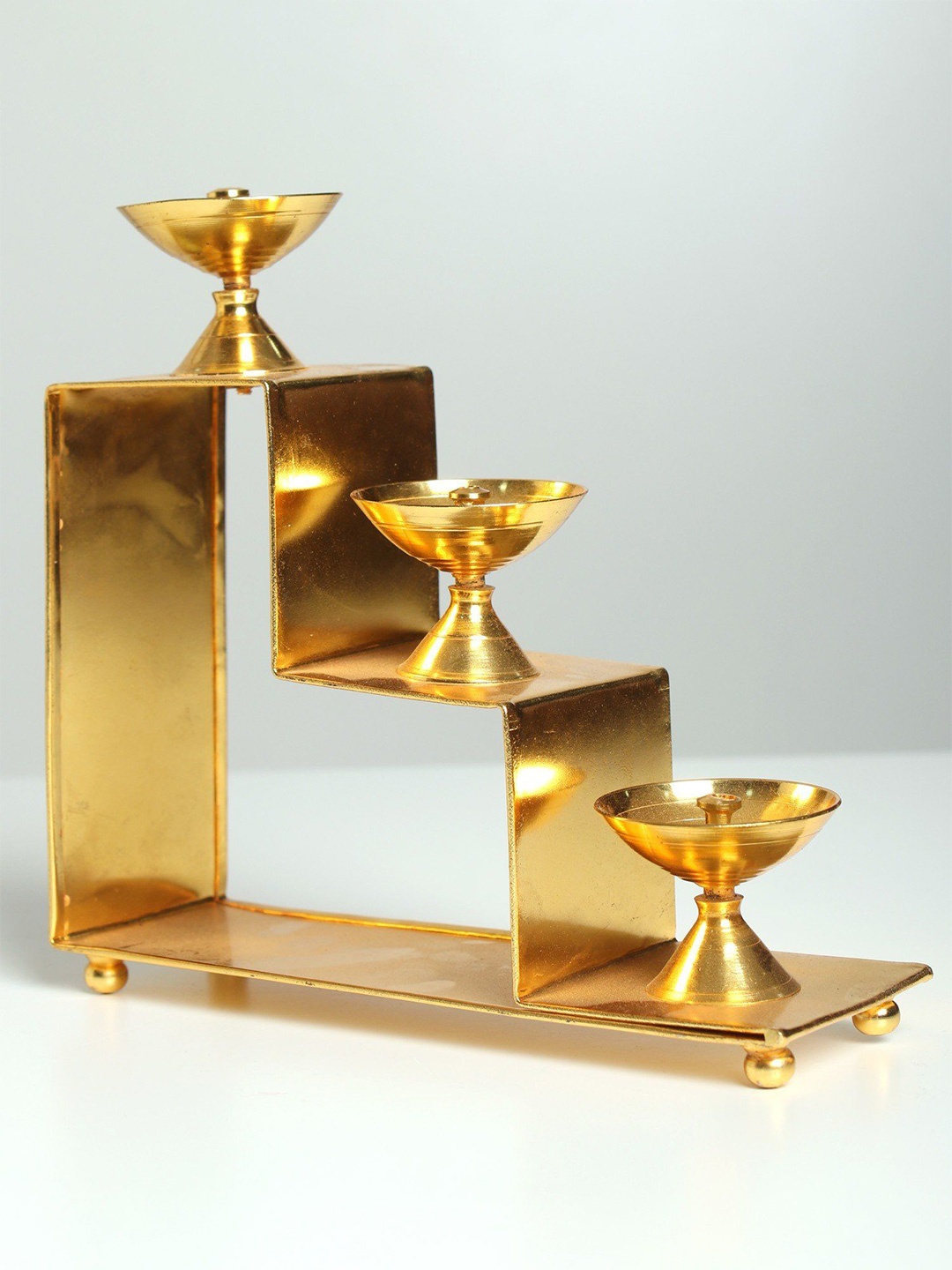 

Exotic India Brass Lamps on Three Steps Stair Stand, Gold