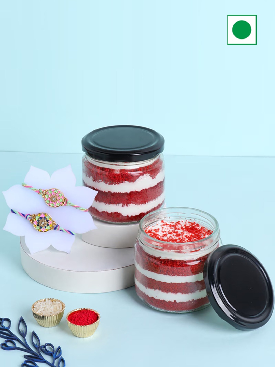 

Floweraura Set of 2 Floral Pearl Rakhi With Red Velvet Jar Cake, Gold