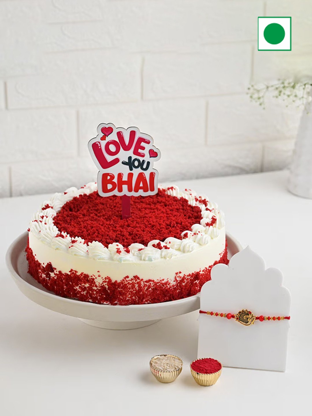 

Floweraura 2-Pcs Rakhi & Red Velvet Cake With Topper 0.5 Kg, Gold