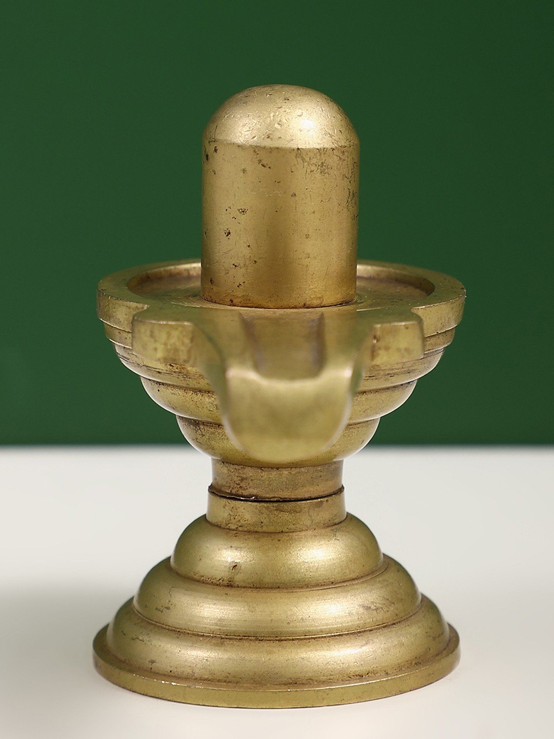 

Exotic India Gold toned Brass Shiva Linga Statue