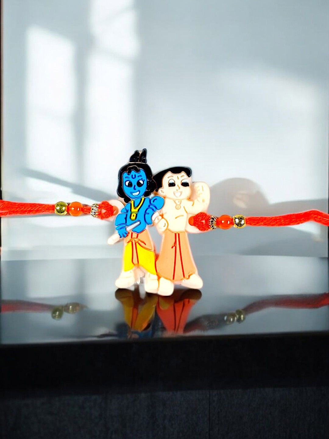 

ADIVA Load Krishna And Bheem Thread Rakhi With Roli Chawal, Red
