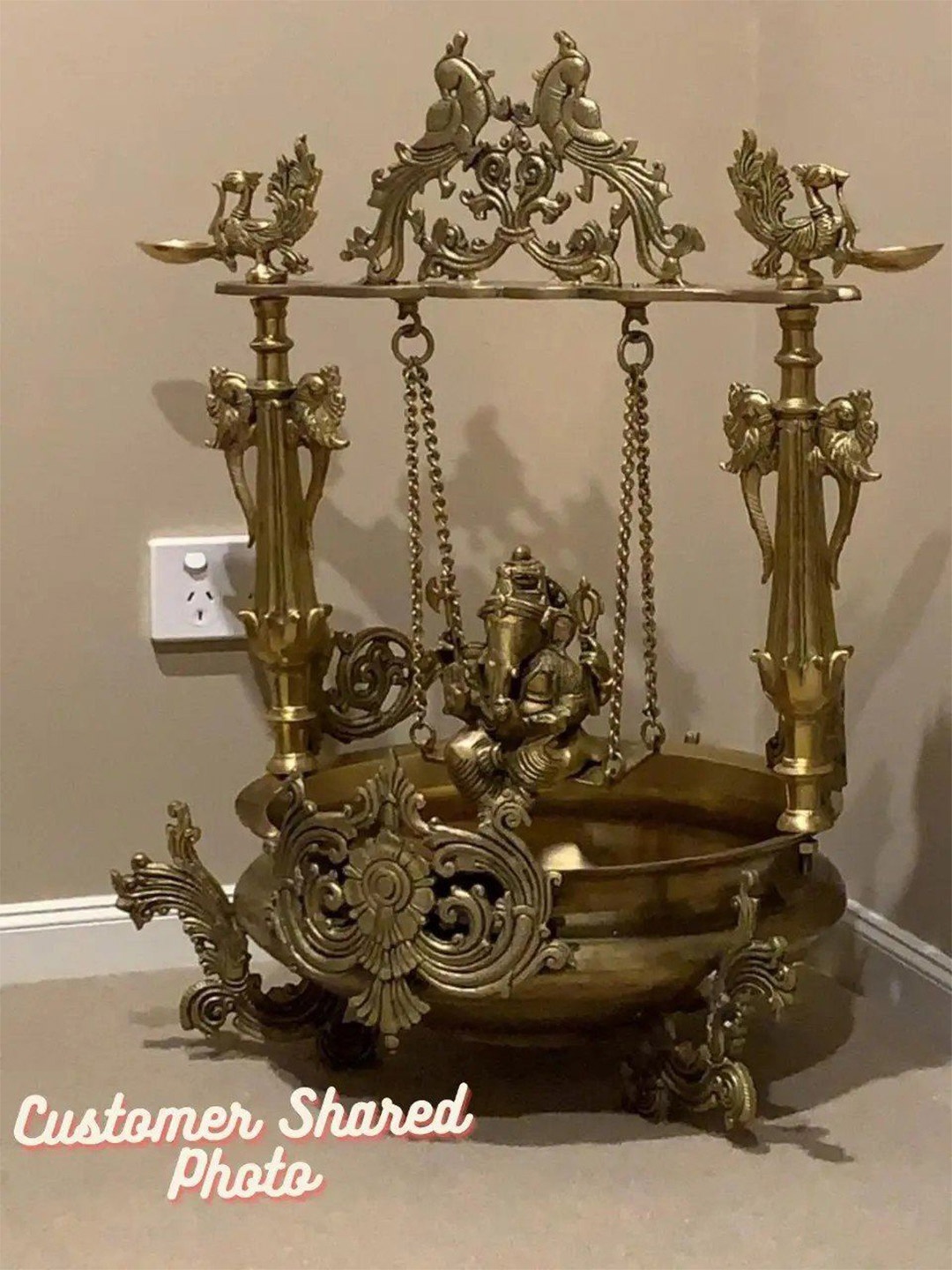 

Exotic India 27" Brass Swinging Lord Ganesha Urli with Miniscule Peacock Lamps, Yellow