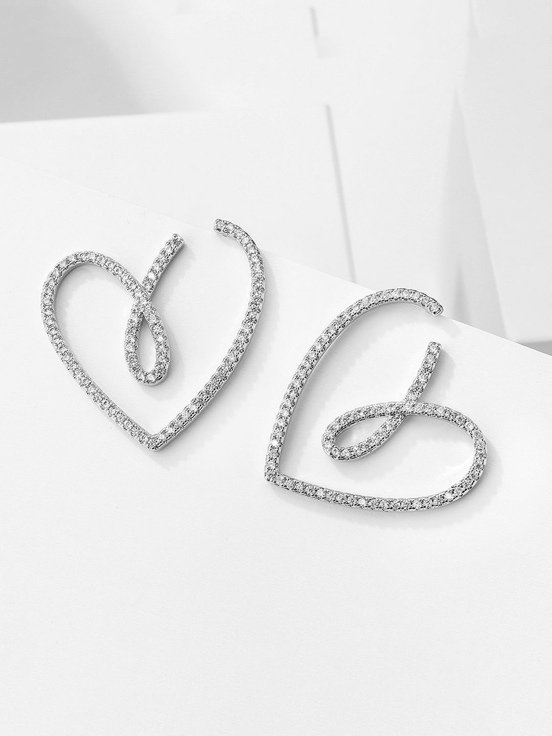 

Krelin Rhodium Plated Twisted Hollow Out Heart Shaped Studs, Silver