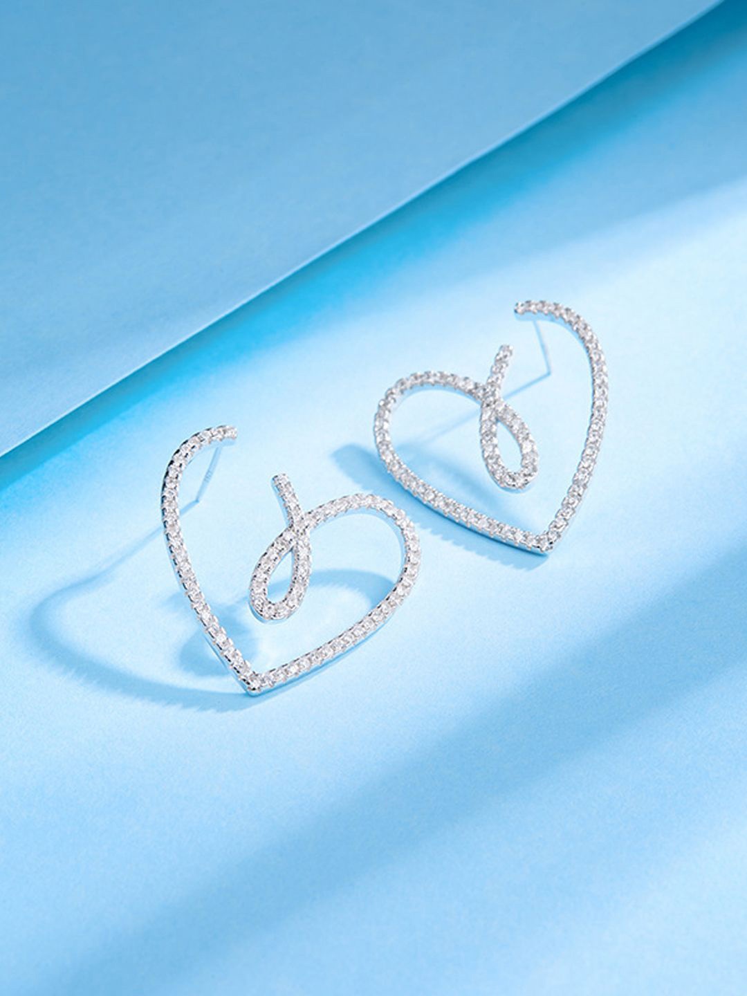 

Krelin Rhodium Plated Twisted Hollow Out Heart Shaped Drop Earrings, Silver