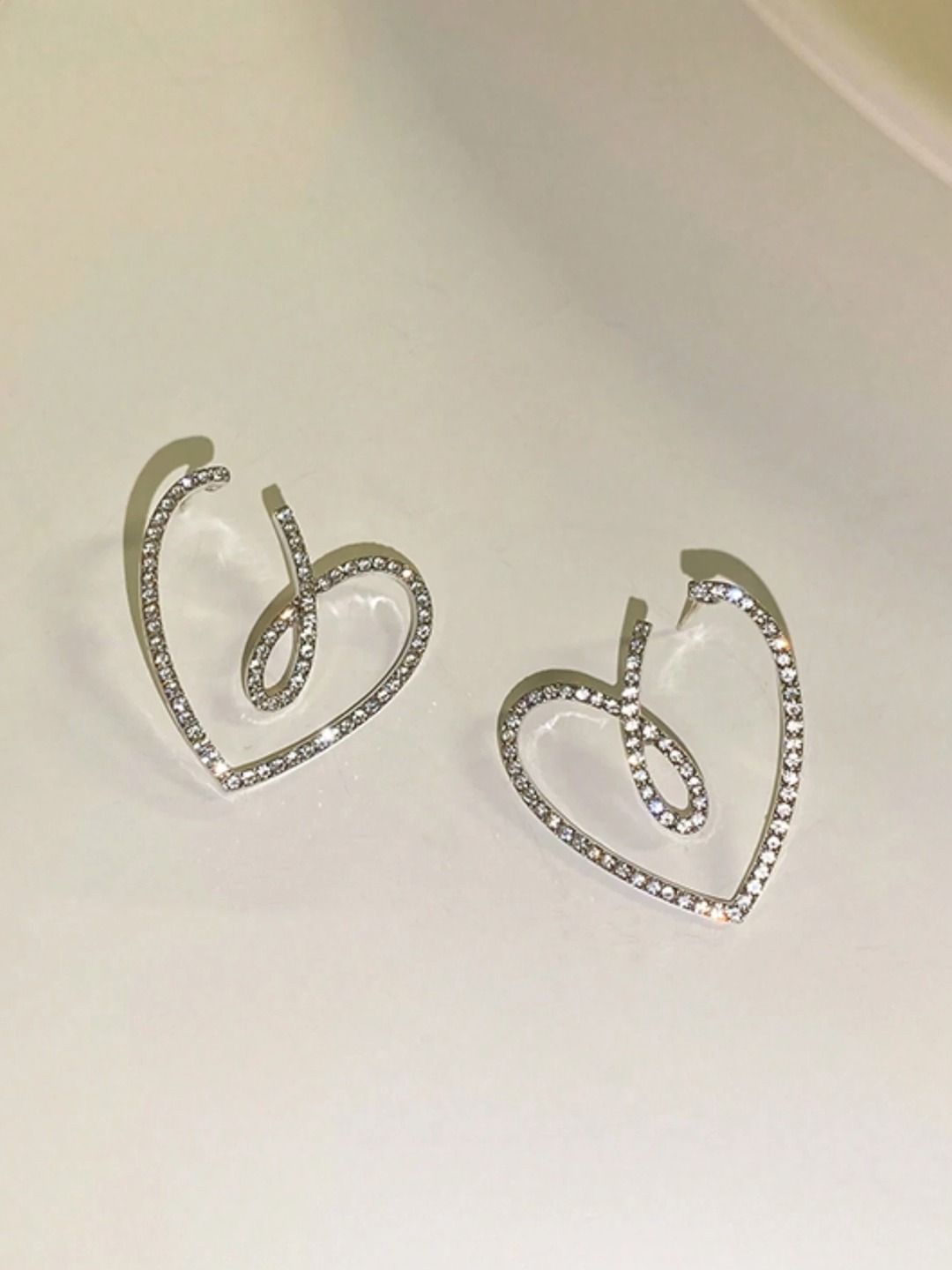 

Krelin Rhodium-Plated Rhinestone Twisted Hollow Out Heart Shaped Studs, Silver