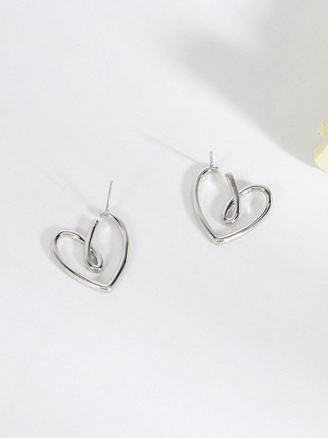 

Krelin Rhodium-Plated Stone Studded Twisted Hollow Out Heart Shaped Drop Earrings, Silver