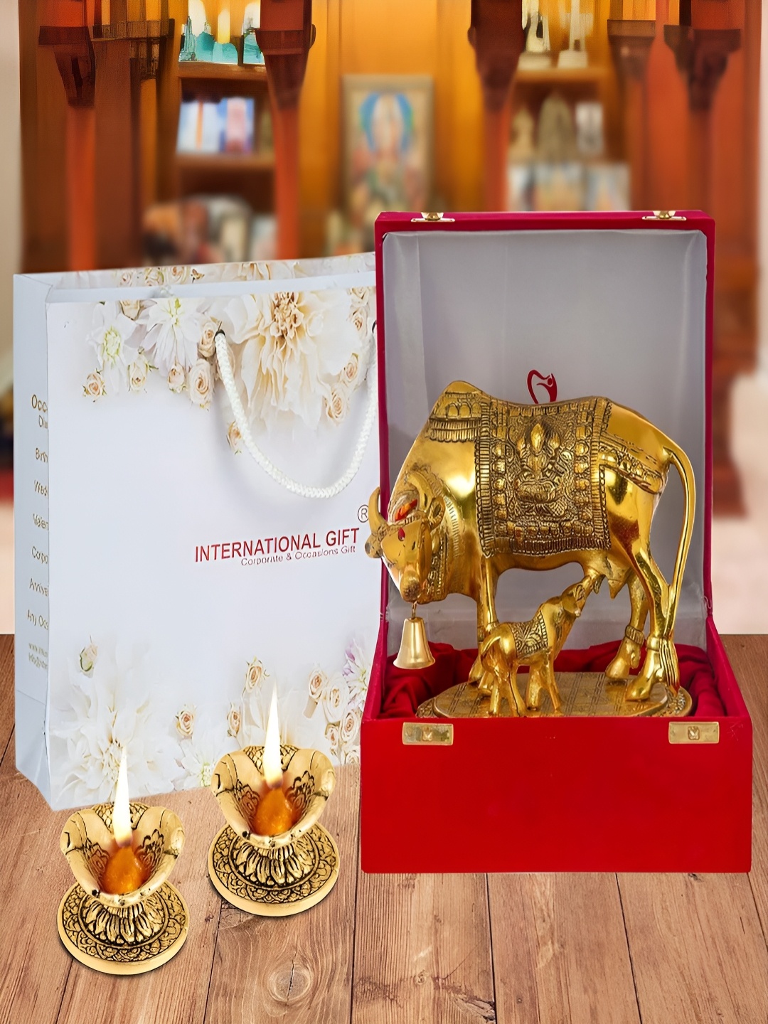 

INTERNATIONAL GIFT Yellow & Red 3 Pieces Kamdhenu Cow & Calf Idol With Hand Diyas, Gold