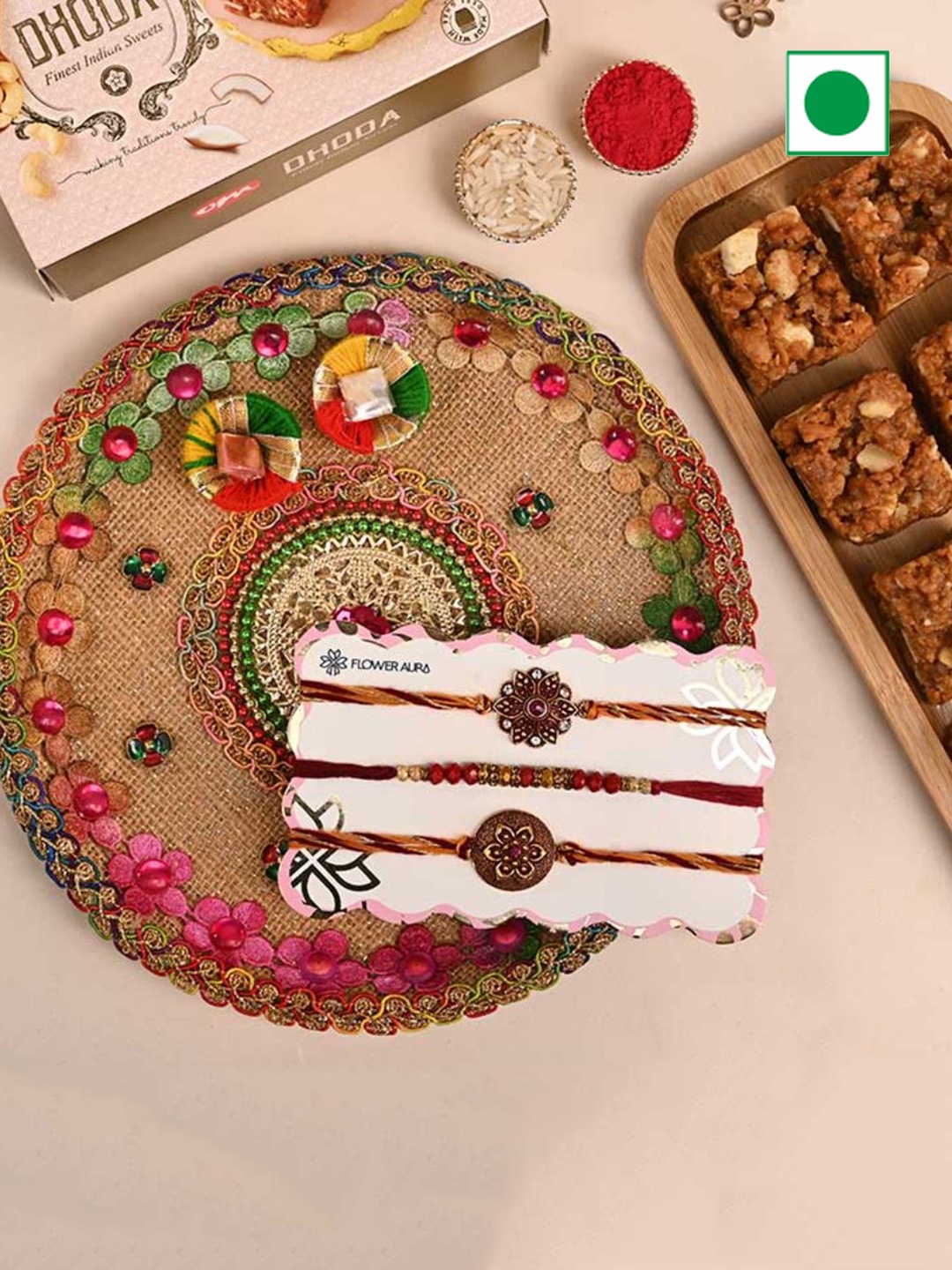 

Floweraura 3-Pcs Rakhi With Dodha Burfi & Flower Engraved Tika Thali Gift Set, Red