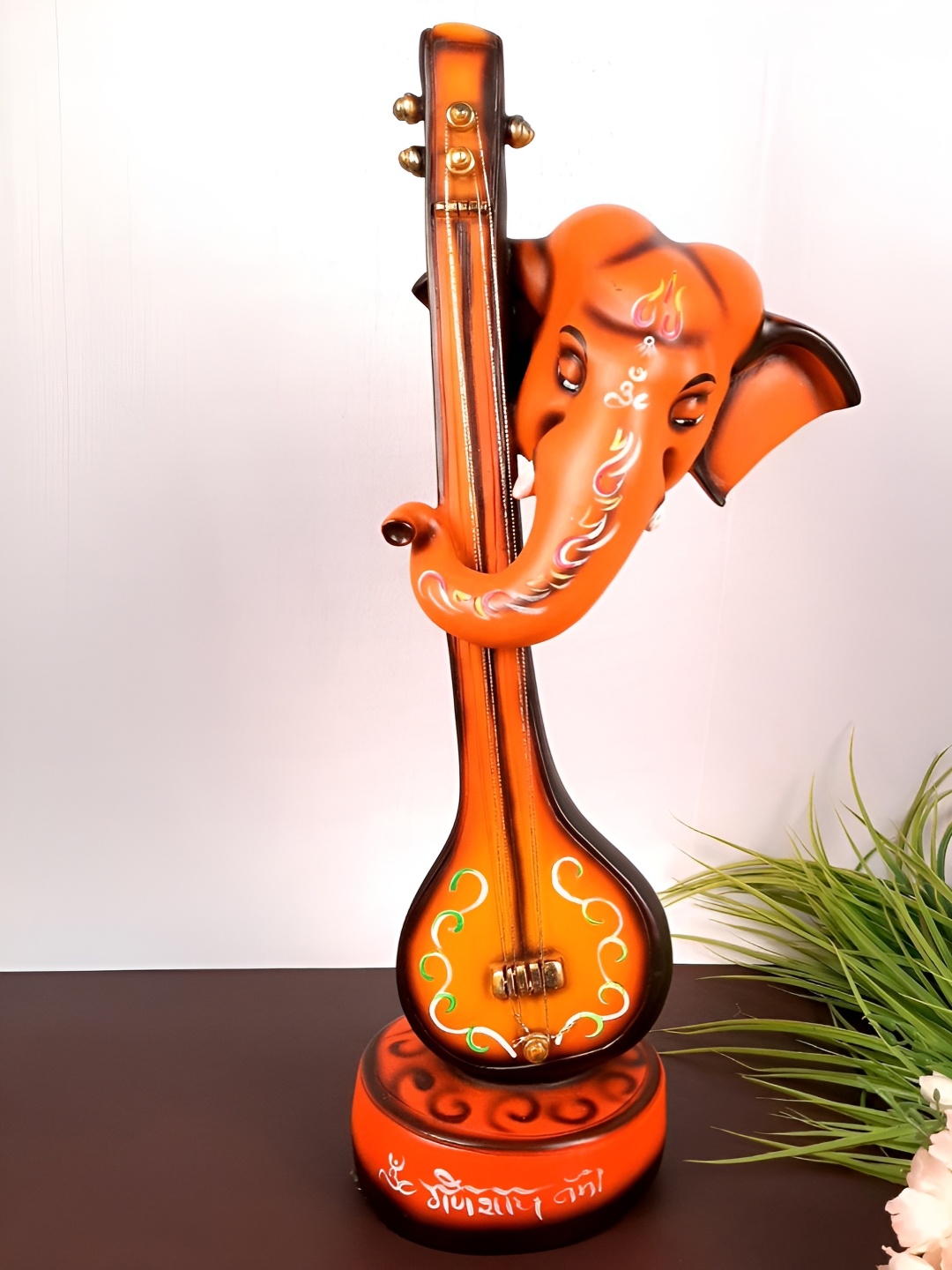 

apka mart Orange Colored & Brown Ganesh With Sitar Idol Showpiece