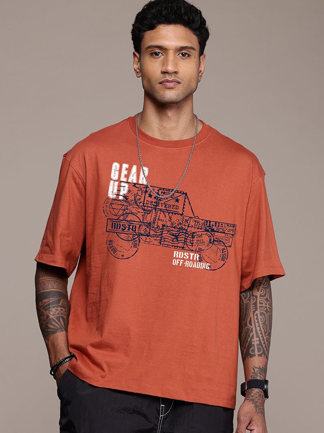 

The Roadster Lifestyle Co. Men Graphic Printed Round Neck Cotton Oversized T-Shirt, Rust