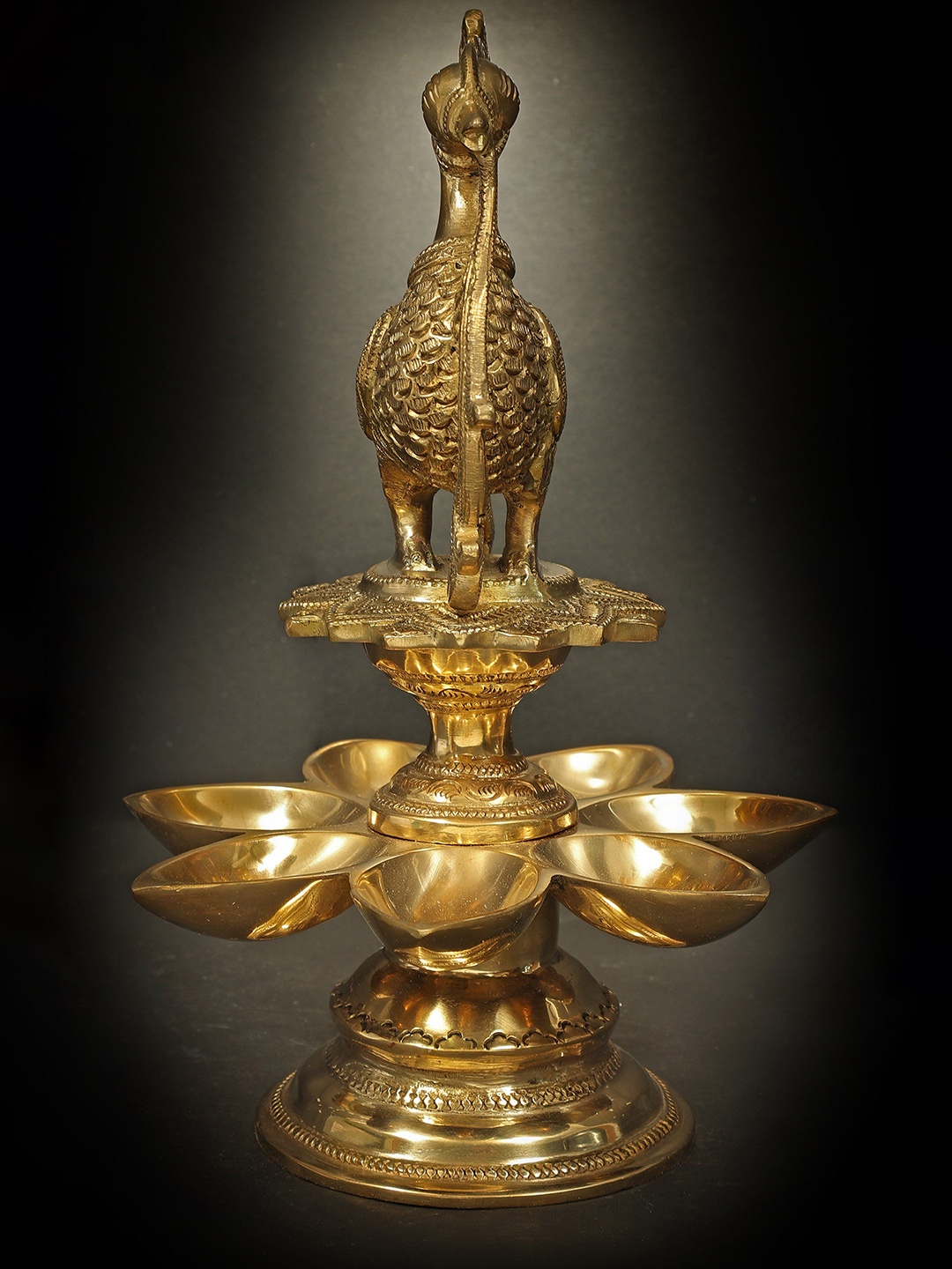 

Exotic India 6" Brass Peacock Seven Wick Oil Lamp, Gold