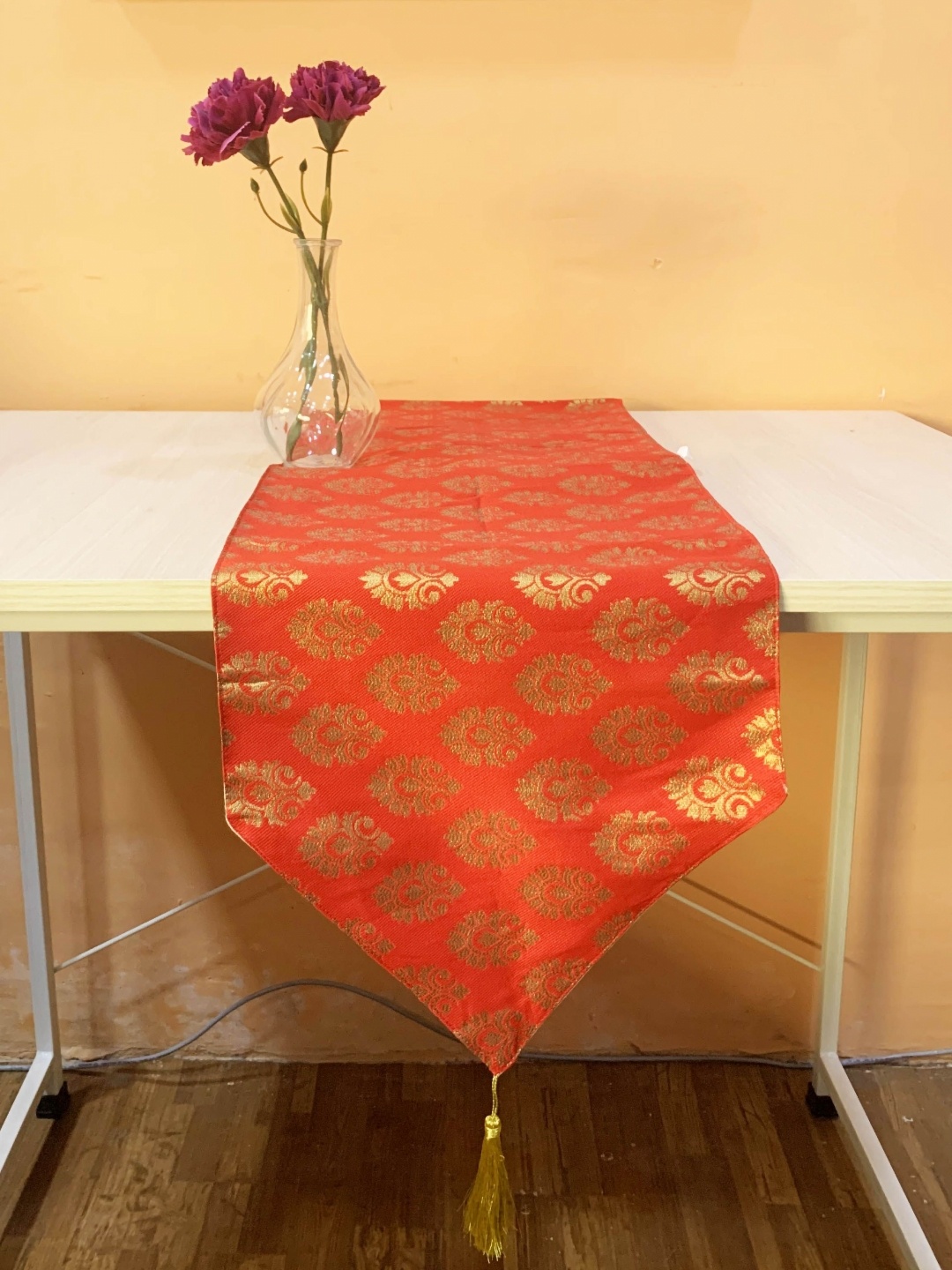 

Pink Parrot Orange coloured & Gold Toned Ethnic Motifs Printed Table Runner