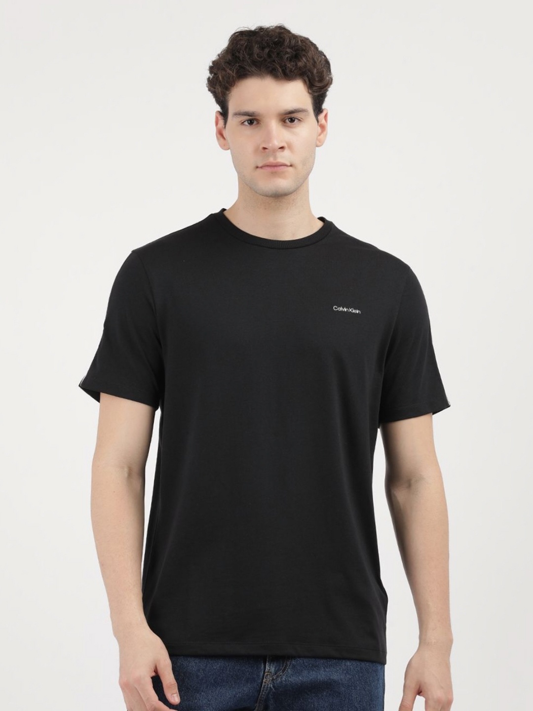 

Calvin Klein Jeans Men Solid Round Neck Cotton T-Shirt, Black