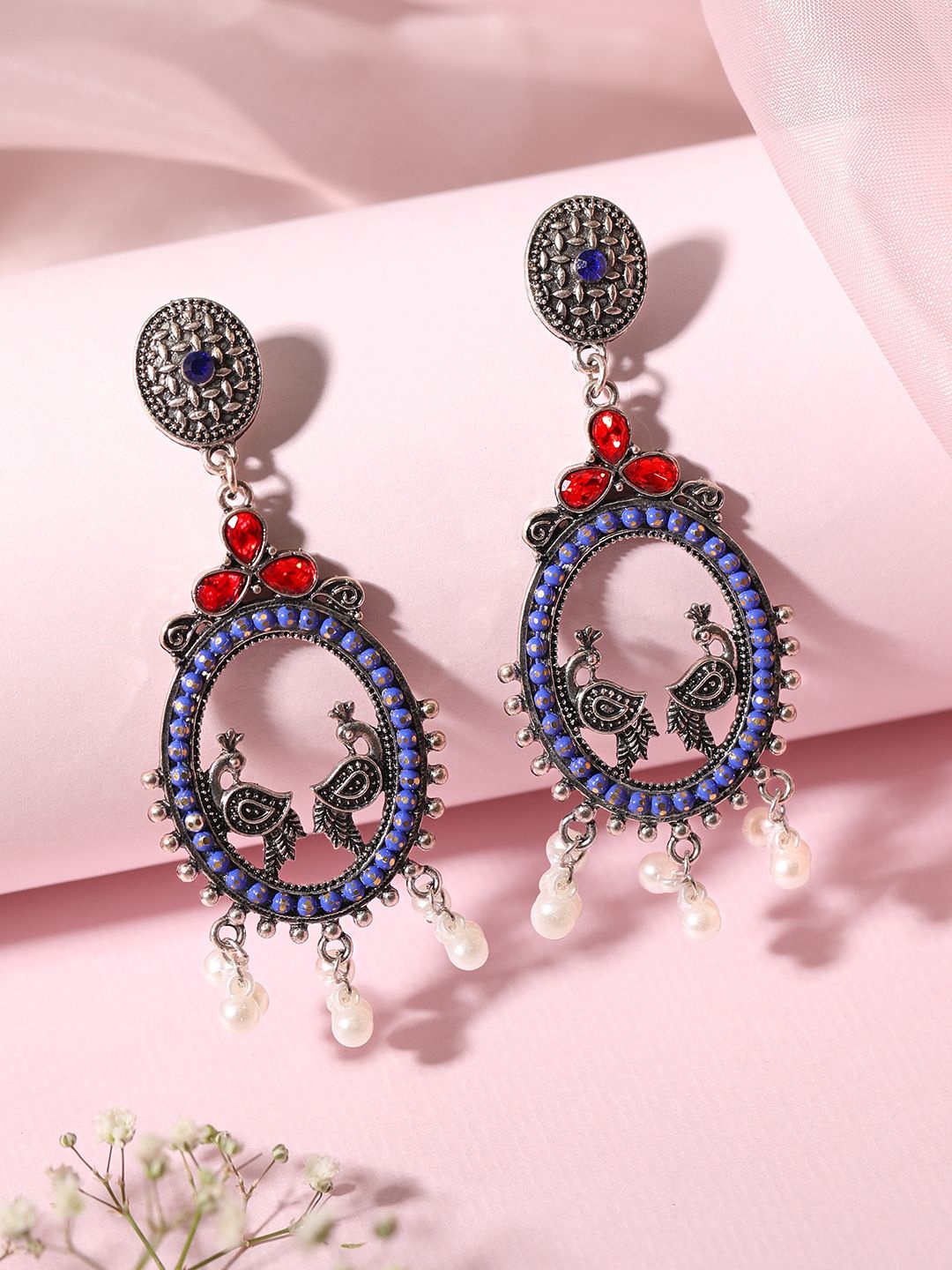 

Rubans Oxidized Silver-Plated Oval Peacock Drop Earrings with Blue & Red AD & Pearl Beads