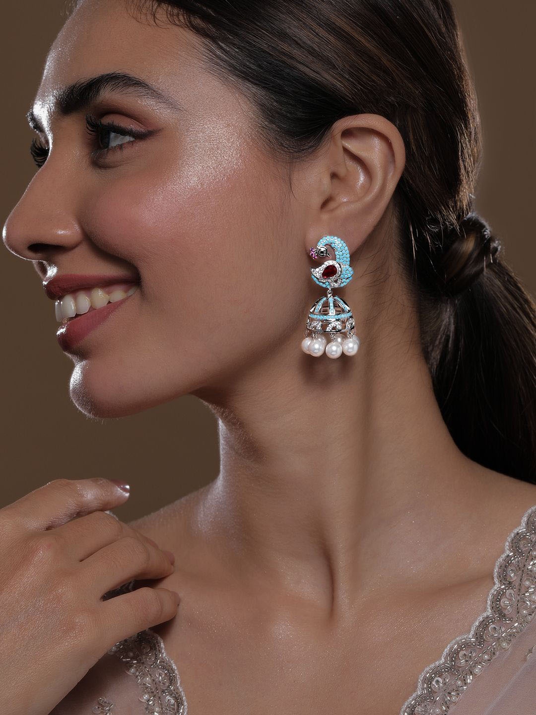 

Rubans Rhodium-Plated Turquoise Blue & Ruby AD & Zirconia Studded Peacock Design Jhumka, Silver