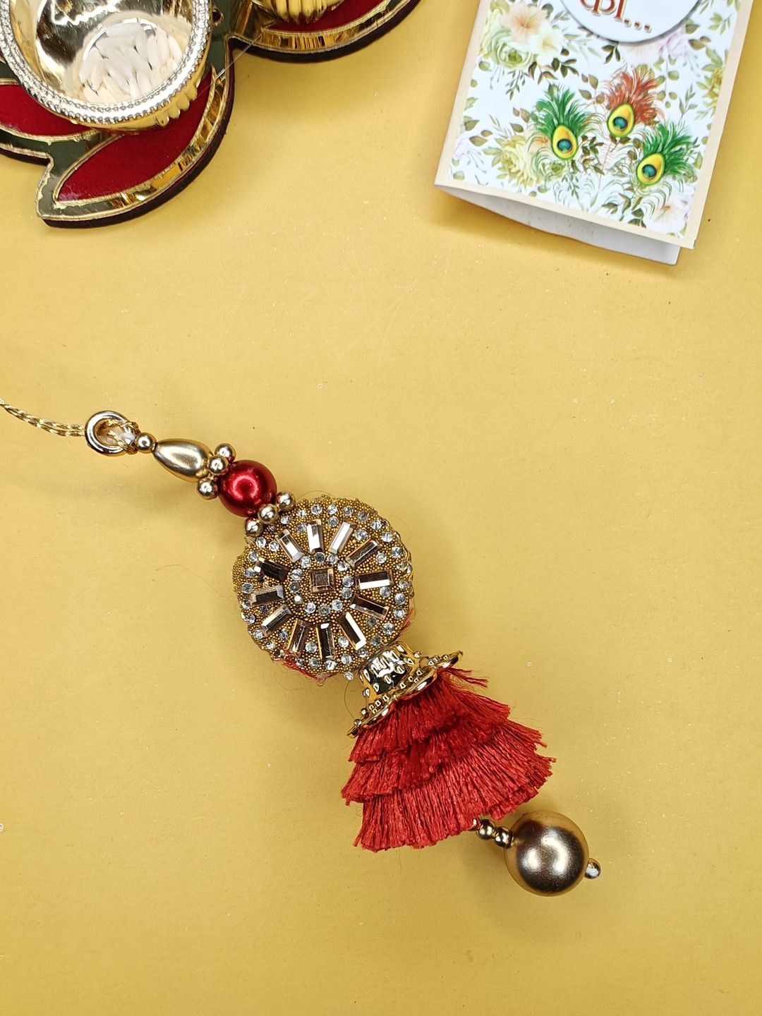 

NVR Stone-Studded & Beaded Lumba Rakhi With Roli Chawal, Red