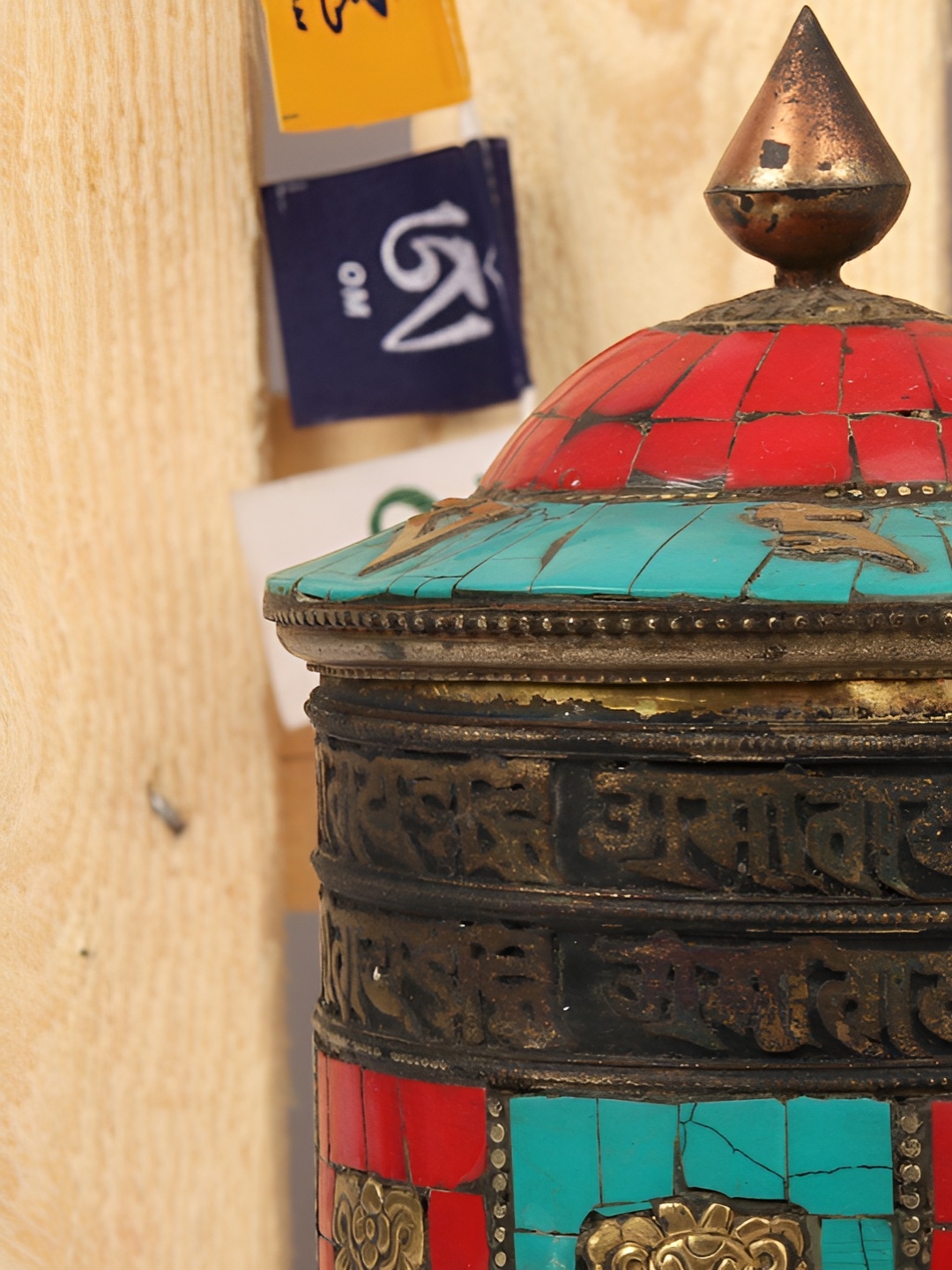 

Exotic India Red Textured Rotating Prayer Wheel & Mantras Engraved Showpiece