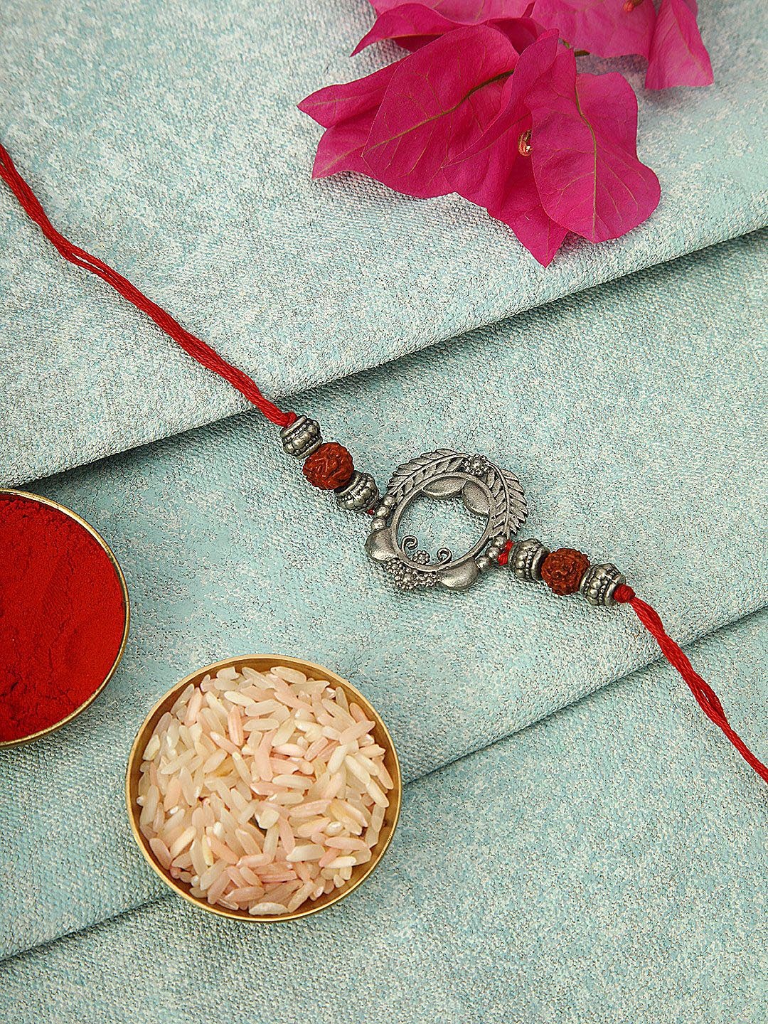 

Anouk Red Silver Plated Oval Ornate Thread Rakhi