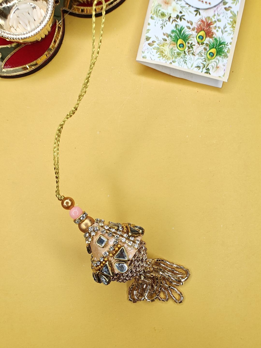 

NVR Stone Studded & Beaded Lumba Thread Rakhi With Roli Chawal, Gold