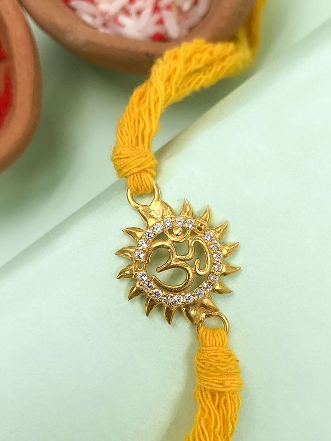 

Unniyarcha 92.5 Sterling Silver Om Rakhi Thread Rakhi, Yellow