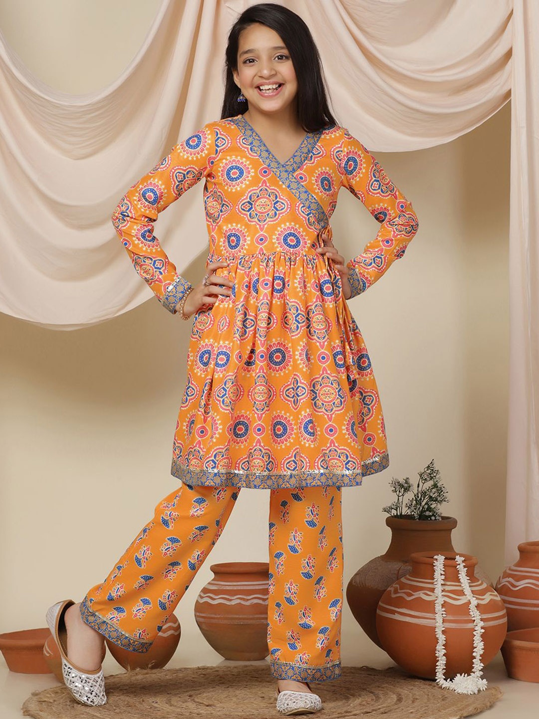 

BAESD Girls Ethnic Motifs Printed V-Neck A-Line Kurta with Trousers, Orange