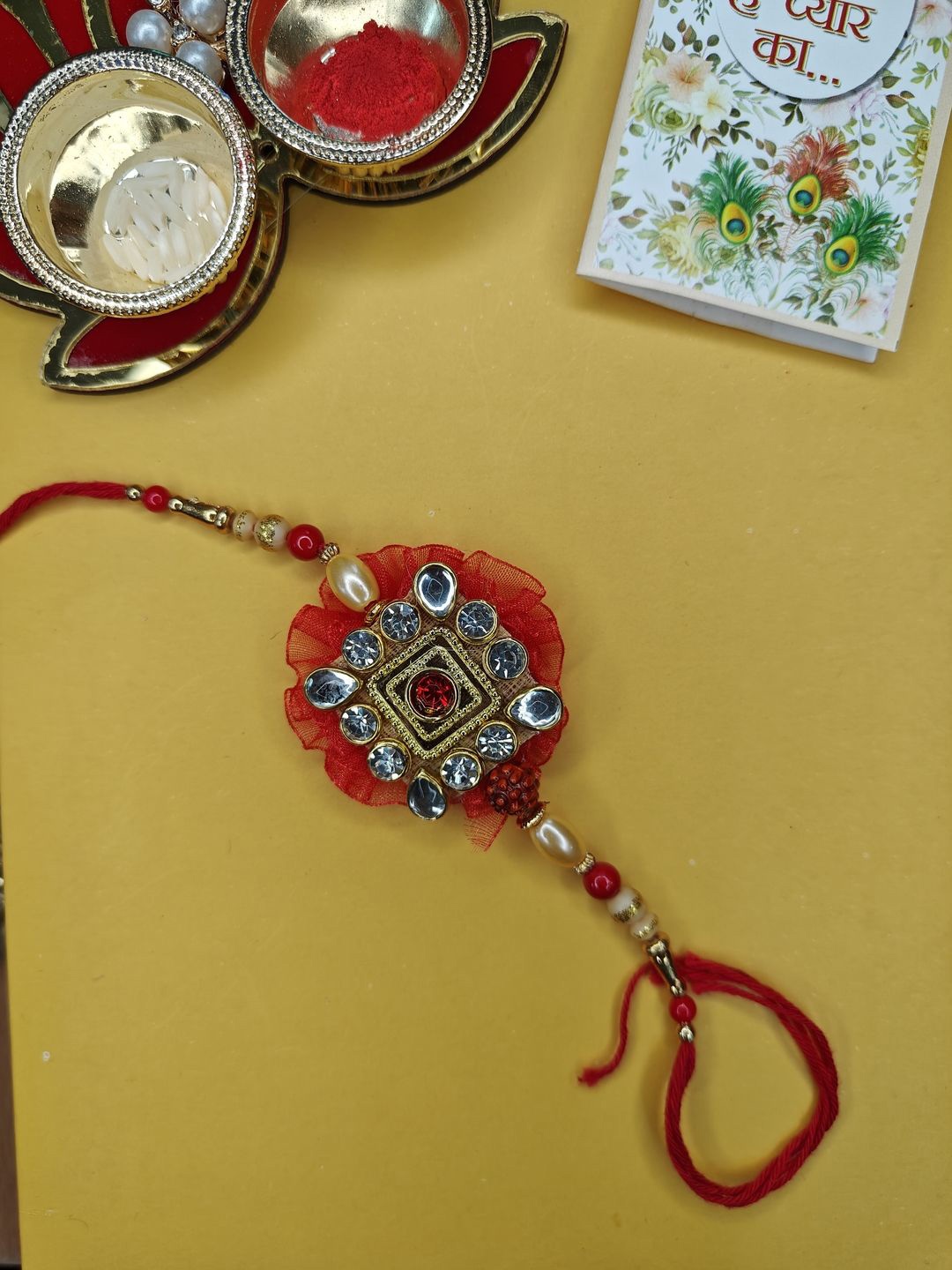 

NVR Stone Studded & Beaded Thread Rakhi With Roli Chawal, Red