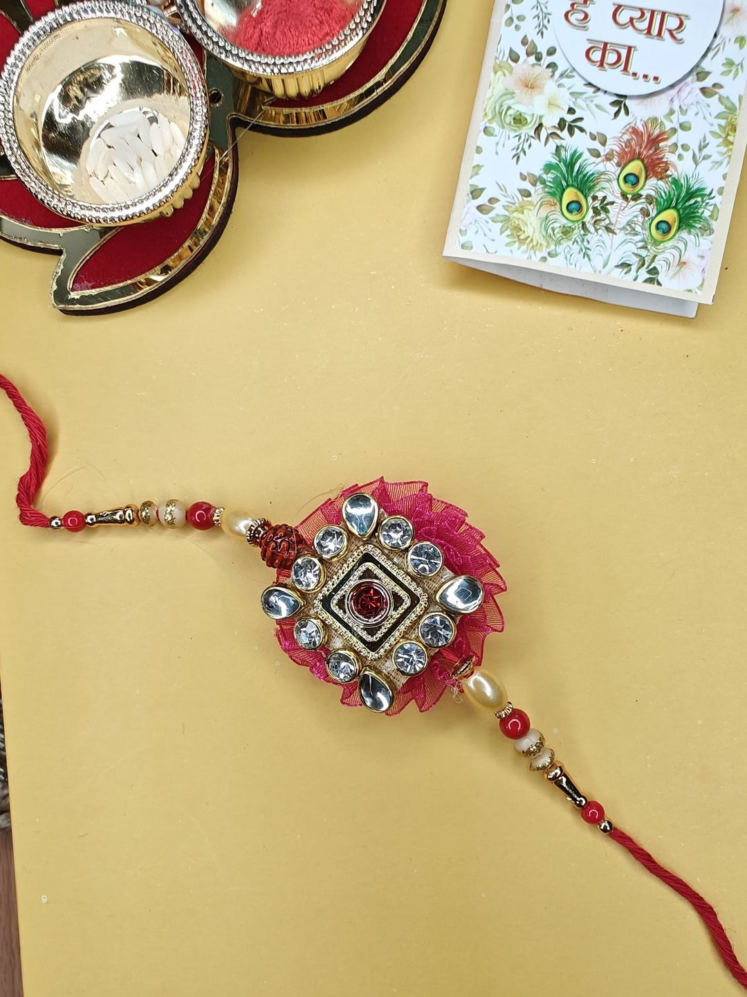 

NVR Stone Studded Thread Rakhi with Roli Chawal, Pink