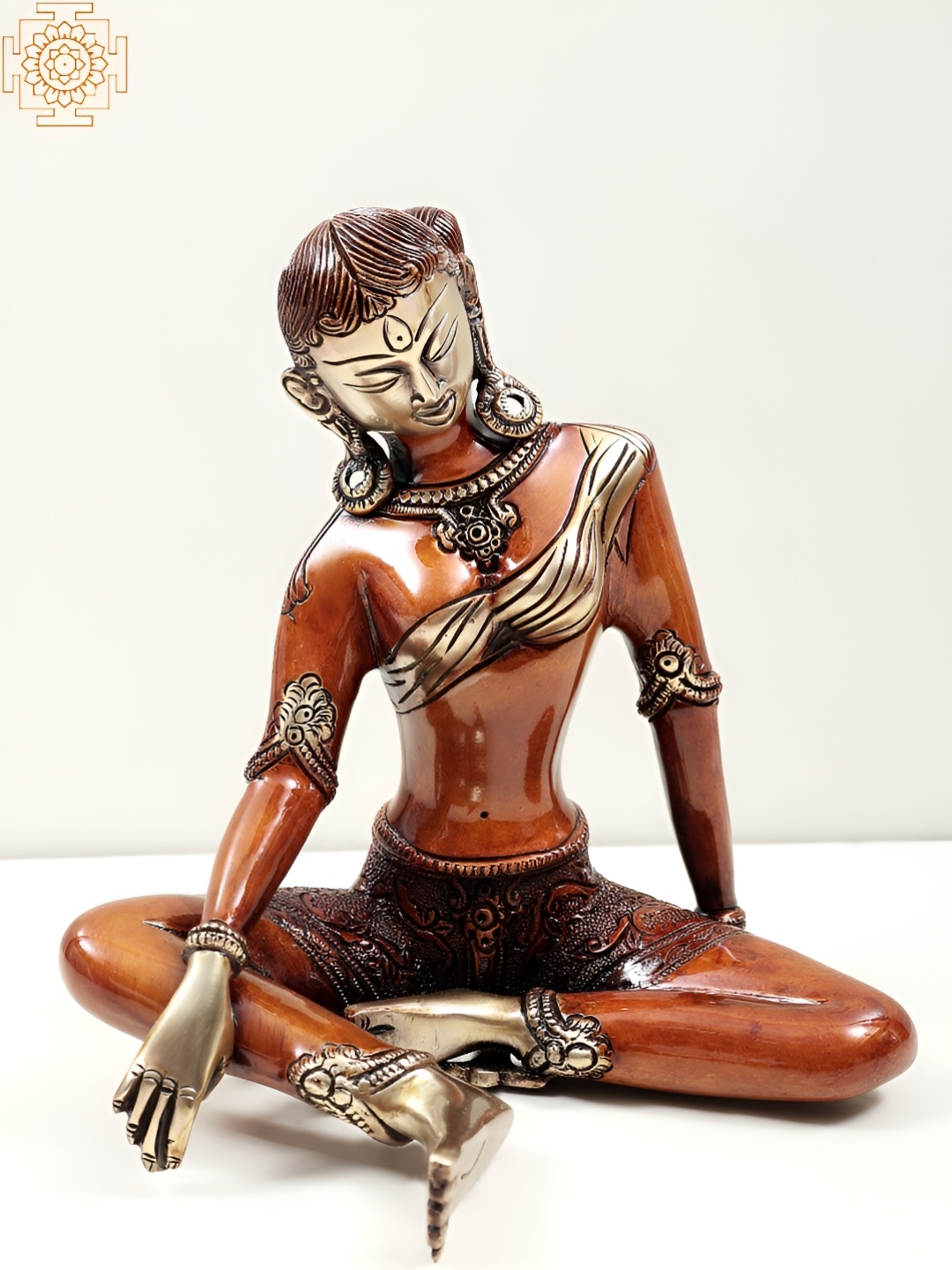 

Exotic India Orange & Brown Tibetan Buddhist Sculpture Showpiece