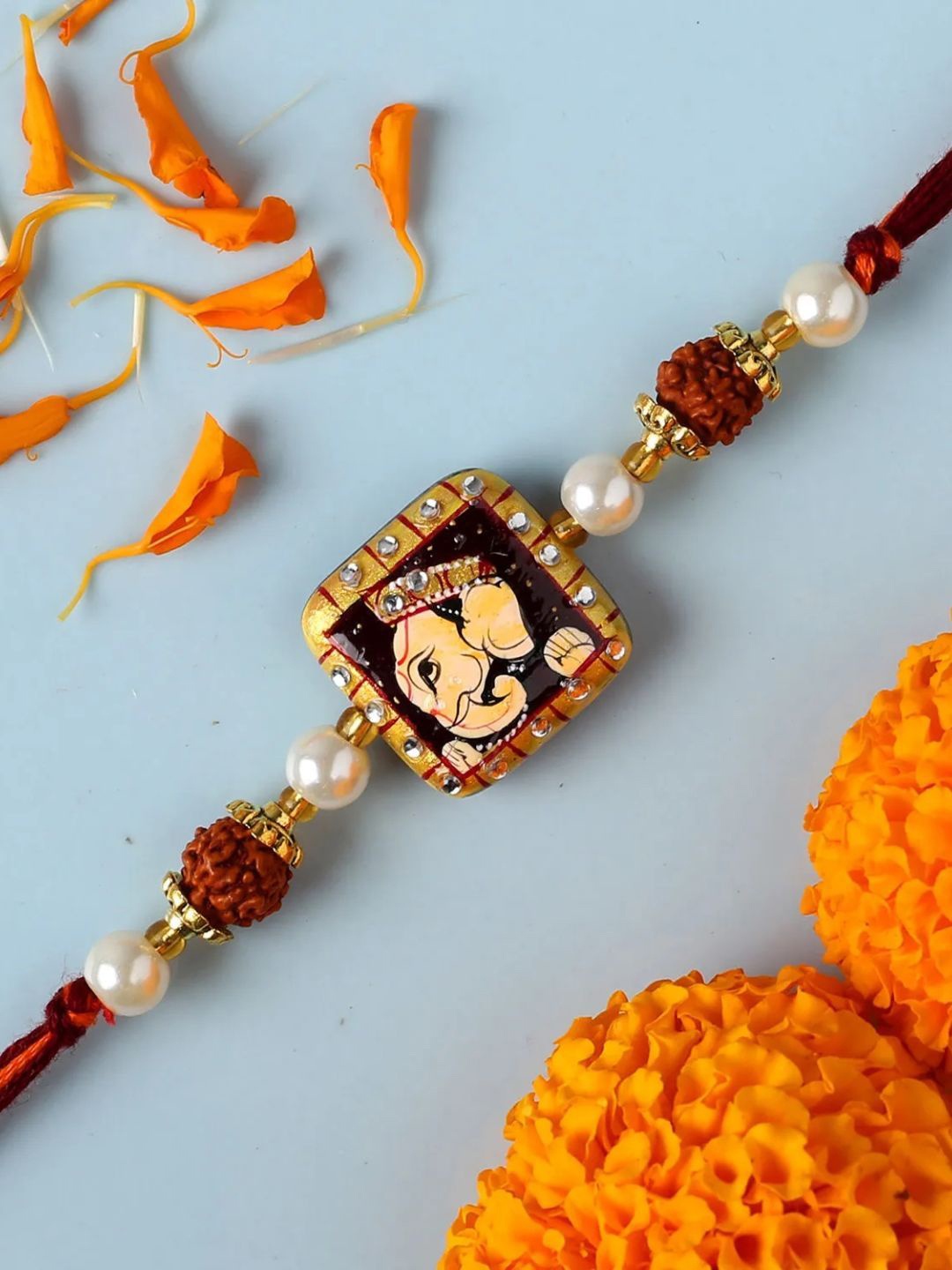 

fnp Divine Rudra Ganesha Pearl Rakhi Lumba Rakhis, Red