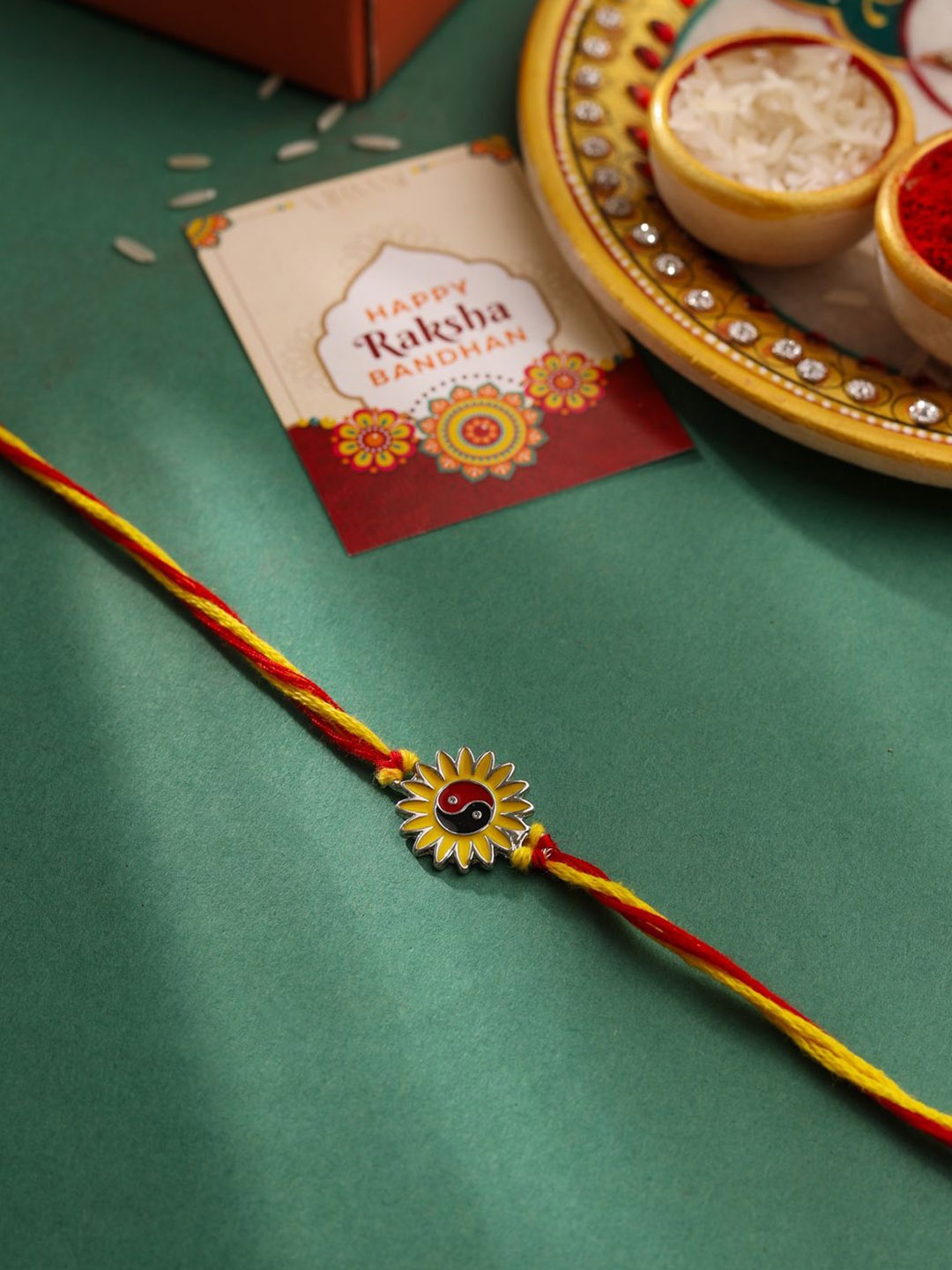 

Natures Buggy Flower Charm Thread Rakhi, Yellow