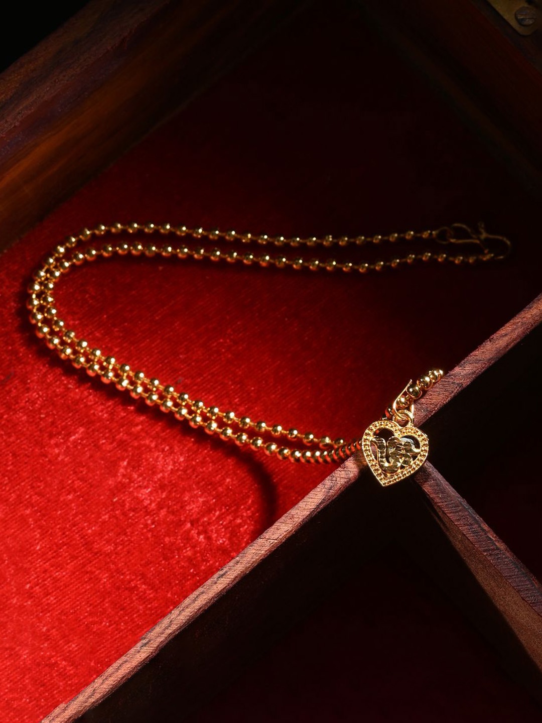 

AanyaCentric Gold-Plated Heart Shaped Om Pendant with Chain