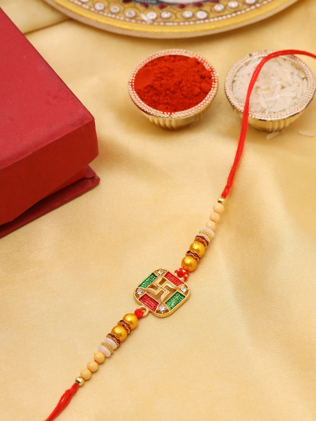 

Natures Buggy Religious Swastika Beaded Thread Rakhi, Gold