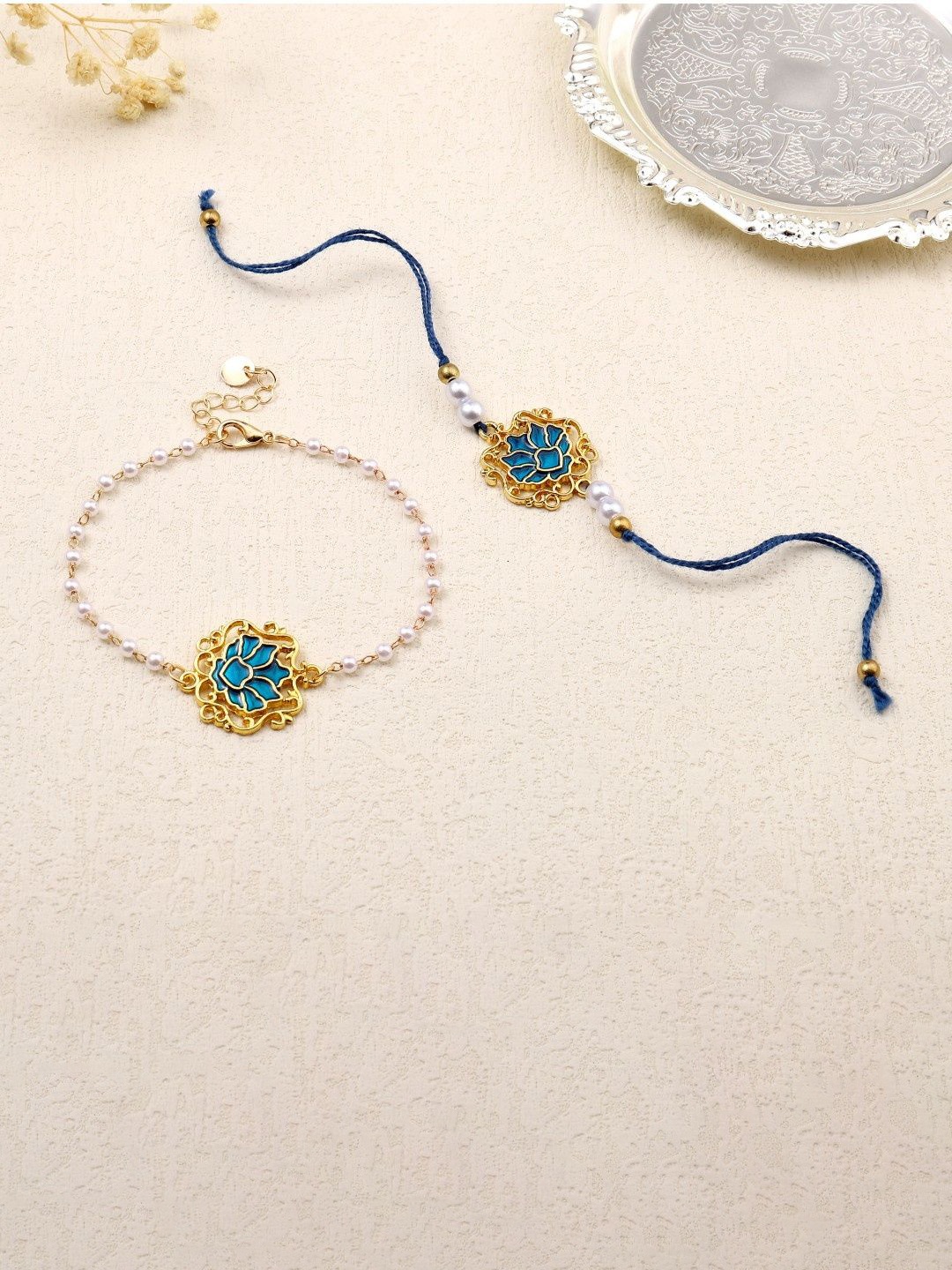 

SALTY Sapphire Lotus Charm Bhaiya and Bhabhi Rakhi, Gold