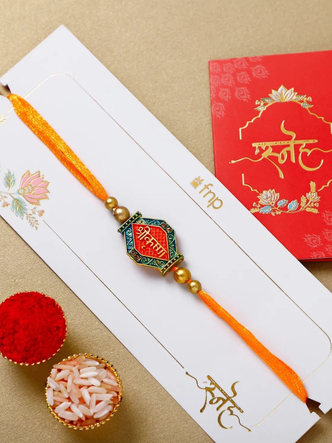 

fnp Krishnas Heartstrings Rakhi Magical Evil Eye, Orange