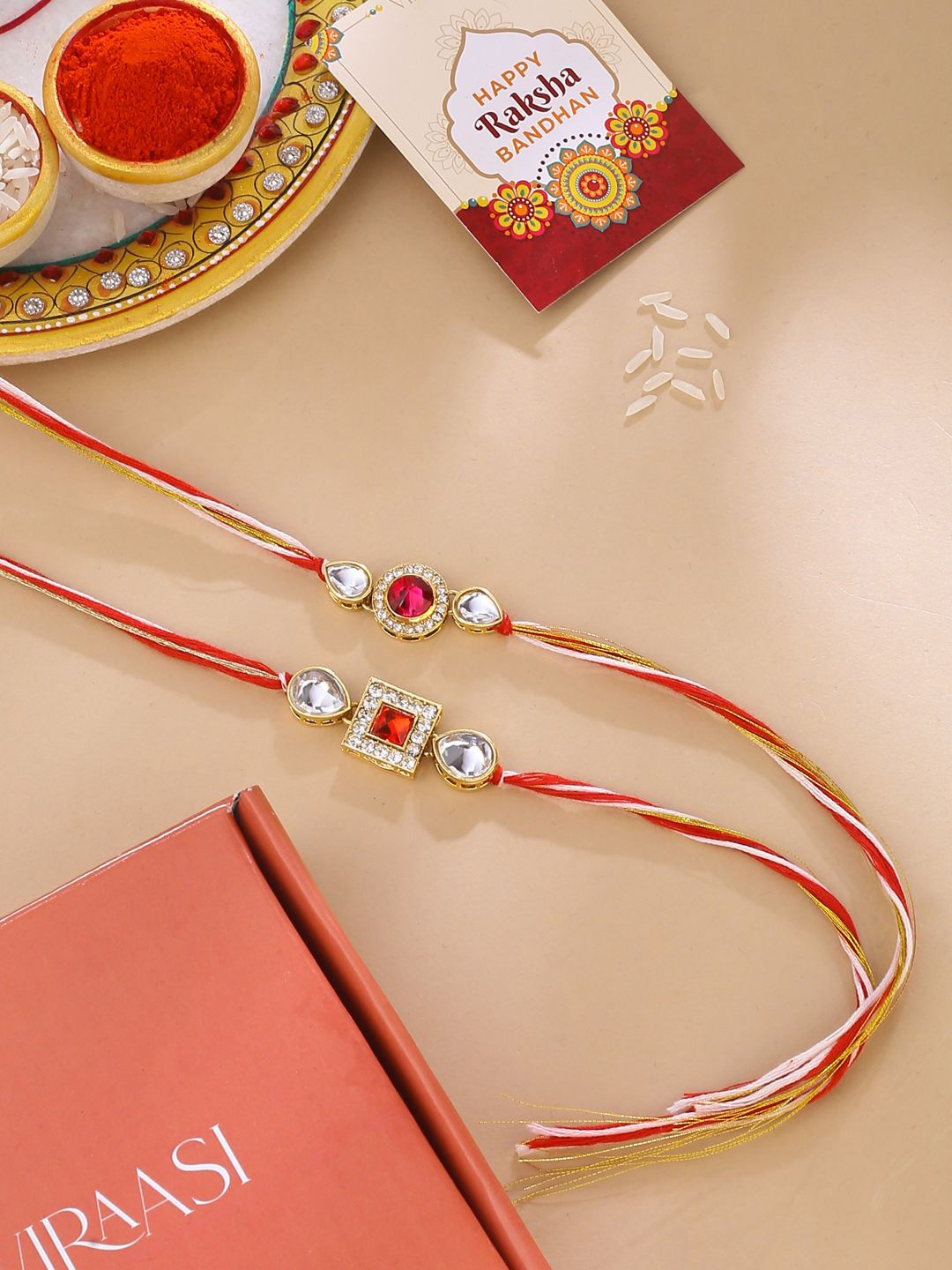 

Natures Buggy Set of 2 Stone Studded Thread Rakhis, Gold