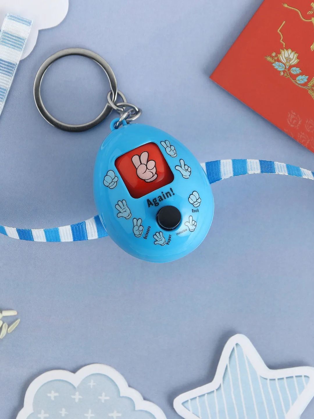 

fnp Playful Rock Paper Scissors Toy Rakhi Blue Silver Selections