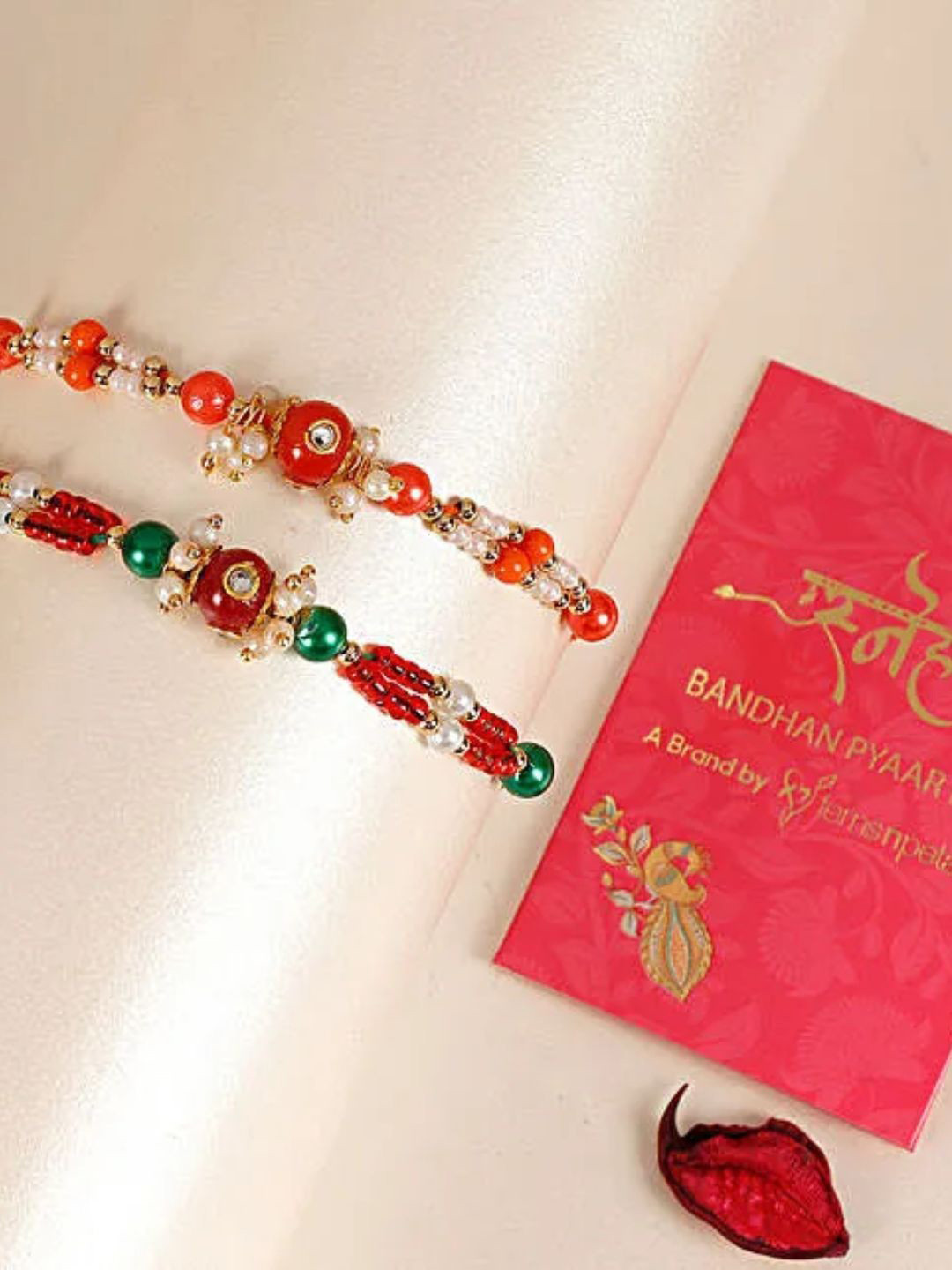 

fnp Sneh Multicolour Bead Rakhi Set of 2 Bhaiya-Bhabhi Rakhis, Red